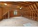 Unfinished attic space shows potential, exposed wood framework and window for natural light at 4637 Gold Finch Dr, Denver, NC 28037