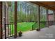 Inviting covered back porch overlooking a spacious backyard with lush green lawn at 4637 Gold Finch Dr, Denver, NC 28037