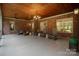 Covered back porch showcasing brick walls, rocking chairs, and a peaceful outdoor setting at 4637 Gold Finch Dr, Denver, NC 28037