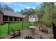 Backyard with seating around a fire pit featuring manicured lawn and wood privacy fence at 4637 Gold Finch Dr, Denver, NC 28037
