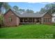 Backyard with manicured lawn and view of the covered porch and home exterior at 4637 Gold Finch Dr, Denver, NC 28037