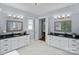 Bright bathroom boasts dual vanities, framed mirrors, neutral paint, and modern lighting fixtures at 4637 Gold Finch Dr, Denver, NC 28037
