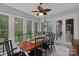 Dining room features large windows providing views of the outdoor greenery and a ceiling fan at 4637 Gold Finch Dr, Denver, NC 28037