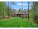 Exterior view of a brick home featuring a manicured front lawn and mature trees at 4637 Gold Finch Dr, Denver, NC 28037