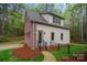 Charming brick and siding home featuring landscaped front yard and black metal fence at 4637 Gold Finch Dr, Denver, NC 28037