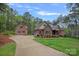 Beautiful brick home with a long driveway, lush lawn, and mature trees in a serene setting at 4637 Gold Finch Dr, Denver, NC 28037