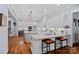 Modern kitchen boasts granite countertops, stainless steel appliances, island seating, and ample cabinetry at 4637 Gold Finch Dr, Denver, NC 28037