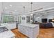 Open-concept kitchen with granite counters, island, and seamless flow to the bright living room at 4637 Gold Finch Dr, Denver, NC 28037