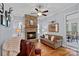 Comfortable living room boasts a stone fireplace, natural lighting, hardwood floors, and stylish decor at 4637 Gold Finch Dr, Denver, NC 28037