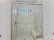 Neutral tiled shower stall with bench and glass door at 4637 Gold Finch Dr, Denver, NC 28037