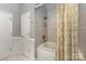 Bathroom features a soaking tub with shower, white tile, and a patterned shower curtain at 481 Patriot Ne Ct, Concord, NC 28025