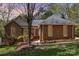 Charming brick home with a well-manicured lawn and mature trees creating a welcoming curb appeal at 481 Patriot Ne Ct, Concord, NC 28025