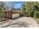 Detached, brick two-car garage with concrete driveway and mature landscaping at 481 Patriot Ne Ct, Concord, NC 28025
