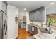 Modern kitchen with granite countertops, stainless steel appliances, and seamless open layout to the living room at 481 Patriot Ne Ct, Concord, NC 28025