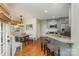 Eat-in kitchen features granite counters, stainless appliances, a breakfast bar, and seating at a wooden table at 481 Patriot Ne Ct, Concord, NC 28025