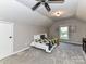 Carpeted attic bedroom with neutral walls, recessed lights, and a ceiling fan at 5043 Hickory Lake Ln, Matthews, NC 28105