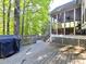 A wooden deck in backyard leads to the screened porch, perfect for enjoying the outdoors at 5043 Hickory Lake Ln, Matthews, NC 28105