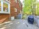 This backyard features a wooden deck and a brick exterior with string lights for outdoor gatherings at 5043 Hickory Lake Ln, Matthews, NC 28105