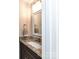 Powder room features a vanity with granite countertop, stylish fixtures, and decorative towels at 5043 Hickory Lake Ln, Matthews, NC 28105