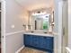 Updated bathroom featuring a double sink vanity and an oversized mirror at 5043 Hickory Lake Ln, Matthews, NC 28105