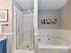 Bright bathroom featuring a tub, shower and vanity with a modern design at 5043 Hickory Lake Ln, Matthews, NC 28105