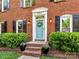 Charming front entrance features a light blue door, potted plants, and brick steps at 5043 Hickory Lake Ln, Matthews, NC 28105