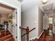 Upstairs hallway features hardwood floors, wood banister, and access to various rooms at 5043 Hickory Lake Ln, Matthews, NC 28105