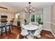Bright kitchen and breakfast nook features modern light fixtures, plenty of natural light, and wooden floors at 5043 Hickory Lake Ln, Matthews, NC 28105