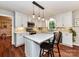 Modern kitchen featuring an island with seating, white cabinets, and stainless steel appliances at 5043 Hickory Lake Ln, Matthews, NC 28105