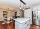 Kitchen area featuring an island with pendant lighting, stainless steel refrigerator, and breakfast area at 5043 Hickory Lake Ln, Matthews, NC 28105