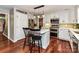Modern kitchen featuring an island with seating, white cabinets, and stainless steel appliances at 5043 Hickory Lake Ln, Matthews, NC 28105