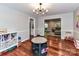 Open living room features hardwood floors, modern light fixture, and views into other rooms at 5043 Hickory Lake Ln, Matthews, NC 28105