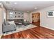 Spacious living room boasts hardwood floors, a sectional sofa, and gallery wall with natural lighting at 5043 Hickory Lake Ln, Matthews, NC 28105