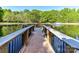 Scenic pond view with a wooden dock and a fountain, perfect for peaceful moments by the water at 5043 Hickory Lake Ln, Matthews, NC 28105
