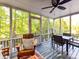 Cozy screened-in porch with a dining table, chairs, and wooded views for relaxation and entertainment at 5043 Hickory Lake Ln, Matthews, NC 28105