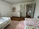 Inviting shared bedroom with hardwood floors, cheerful pink accents, and a glimpse into the living area at 5373 Nc Hwy 16 N Hwy, Taylorsville, NC 28681