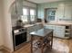 Charming kitchen featuring blue cabinets, butcher block countertops, stainless steel appliances, and an island at 5373 Nc Hwy 16 N Hwy, Taylorsville, NC 28681
