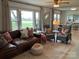 Cozy living room featuring a leather sofa, plush chairs, natural light, and stylish decor at 5373 Nc Hwy 16 N Hwy, Taylorsville, NC 28681