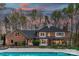 Expansive backyard featuring a refreshing swimming pool and lovely screened-in porch for outdoor relaxation at 5750 Hemby Rd, Matthews, NC 28104