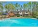Lovely backyard with a sparkling pool, surrounding deck space, and a covered area with seating at 5750 Hemby Rd, Matthews, NC 28104