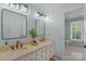 Well-lit bathroom with double sinks, quartz countertop, and neutral finishes at 5750 Hemby Rd, Matthews, NC 28104