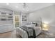 Bedroom with decorative shelving, neutral walls, and a ceiling fan at 5750 Hemby Rd, Matthews, NC 28104