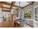 Bright dining area features hardwood floors, wood-beamed ceilings, and a view of the backyard at 5750 Hemby Rd, Matthews, NC 28104