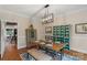 Cozy dining area with wooden table, eclectic furnishings, and view to kitchen at 5750 Hemby Rd, Matthews, NC 28104
