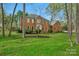 Stately brick home with a well-manicured lawn, mature landscaping, and classic architectural details at 5750 Hemby Rd, Matthews, NC 28104