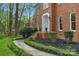 Attractive brick home with manicured front garden beds and a charming entryway with white trim at 5750 Hemby Rd, Matthews, NC 28104