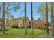 Beautiful brick two-story home with lush green lawn and mature trees, creating a serene setting at 5750 Hemby Rd, Matthews, NC 28104