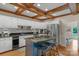Modern kitchen with white cabinets, granite countertops, stainless steel appliances and wood-beamed ceilings at 5750 Hemby Rd, Matthews, NC 28104