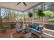 Charming screened porch with outdoor seating, hanging plants, and peaceful backyard views at 5750 Hemby Rd, Matthews, NC 28104