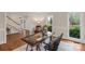 Bright study offers natural light, hardwood floors, and glass desk with unique trestle base at 5750 Hemby Rd, Matthews, NC 28104